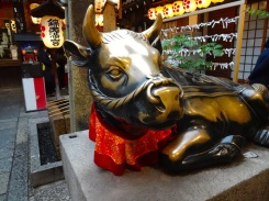 Like the boar in the leather markets of Florence, this bull in Kyoto gets his share of good luck rubs.