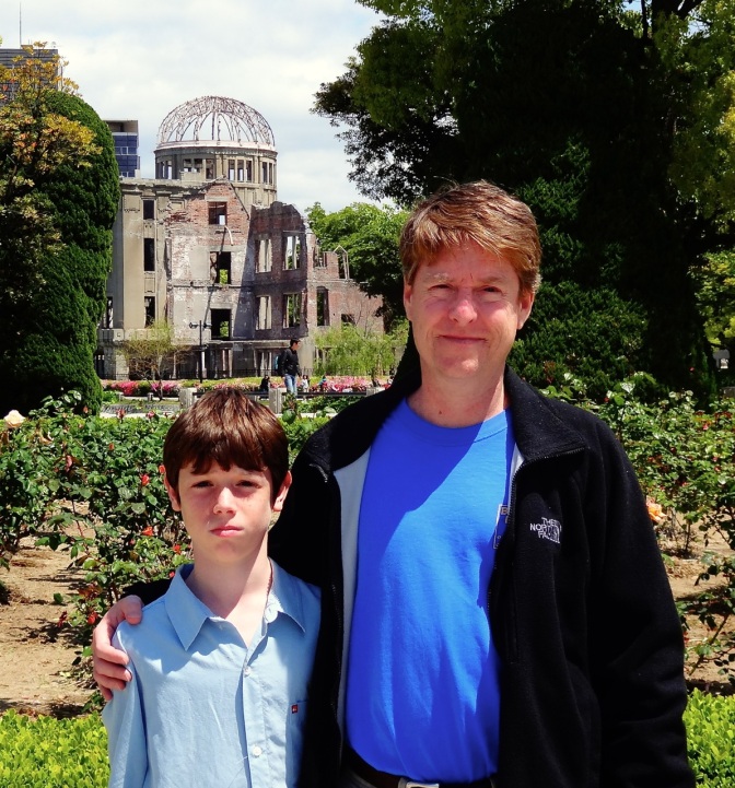 Alex and dad stand in front of the A-Bomb Dome in Hiroshima, Japan.